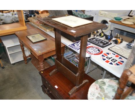 An oak side table with magazine rack to base