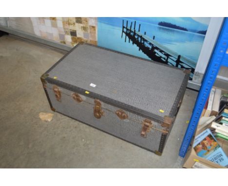A metal bound travel trunk