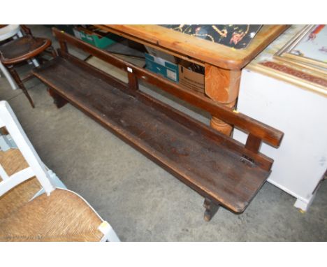 A stained pine bench with folding back