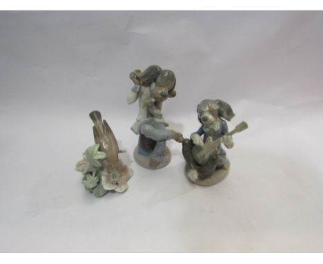 Three Lladro figures - a dog playing guitar, a singing dog and a bird