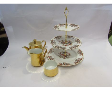 A Royal Worcester three piece gilt tea set and three tier cakestand