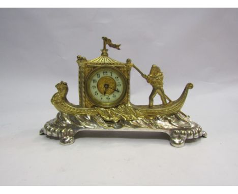 A desk clock depicting a gilt metal gondola on silver plated base. Enamel dial. Made by British United Clock Co. Circa 1893 (