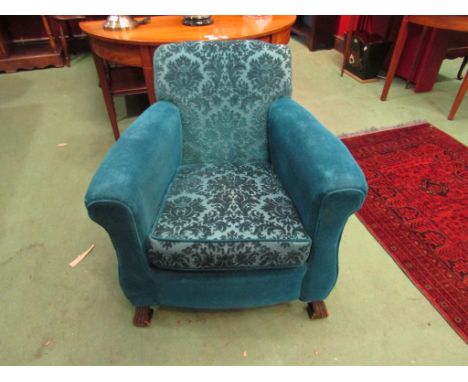 A pair of early 20th Century teal velour armchairs and a matching pouffe 