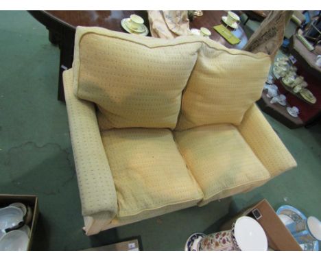 A yellow two seater sofa 