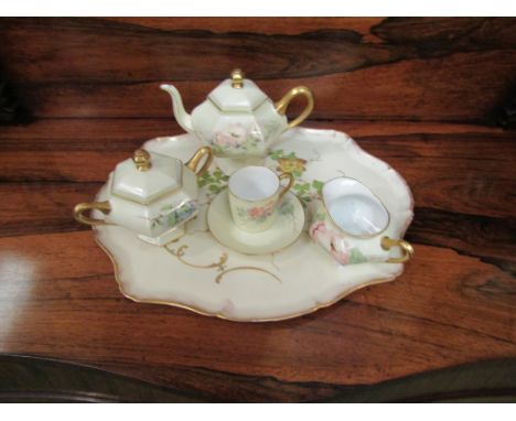 A Limoges tea set for one constituting of teapot, milk jug, sucrier and cup and saucer, with associated tray