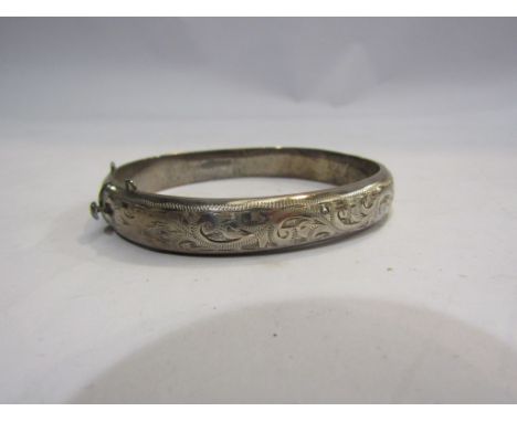 A silver engraved stiff-hinge bangle marked Birmingham