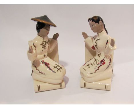 A pair of ceramic Japanese figural book ends, 19cm tall