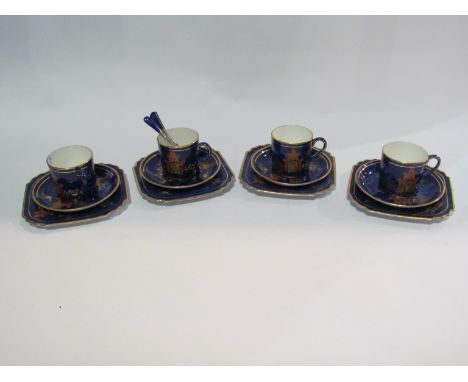 A set of four George Jones &amp; Son cobalt blue coffee cans and saucers in chinoiserie style with pagodas, four silver and e