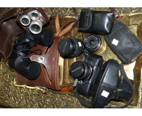 A Pentax MX 35 mm SLR camera with 50 mm, 28 mm & 135 mm lenses; a vintage movie camera by Kodak; other cameras