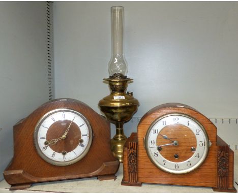 Two 1930's oak cased mantel clocks; a brass oil lamp