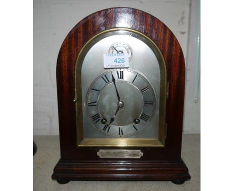 An Edwardian mahogany mantel clock with arch top, silvered dial and ting tang movement