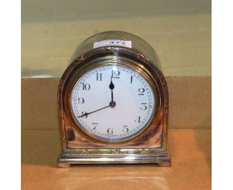 A French mantel clock, silver on brass, with white enamel dial