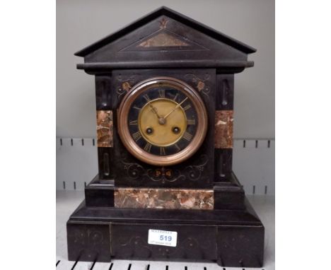 An architectural mantel clock in black marble with brass dial