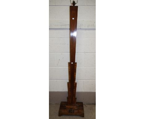 An Art Deco walnut standard lamp with square tapering column, on square stepped base