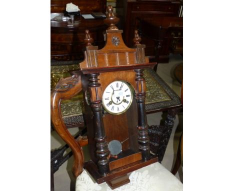 A 19th century small Vienna wall clock in ebonised and walnut case, white dial, and spring driven striking movement