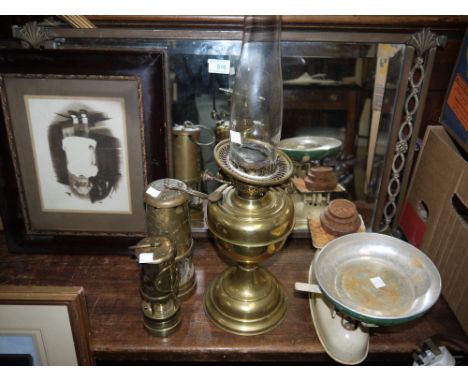 An Edwardian rectangular wall mirror in pierced brass frame; a brass oil lamp; 2 modern miners' lamps and a set of vintage ki