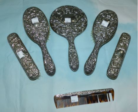 A Victorian style 6 piece dressing table set with extensive embossed decoration, comprising pair of hairbrushes, pair of clot