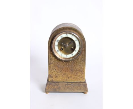 A late 19th/early 20th Century gilt metal mantel clock, with embossed case and enamel dial, 26cm high  