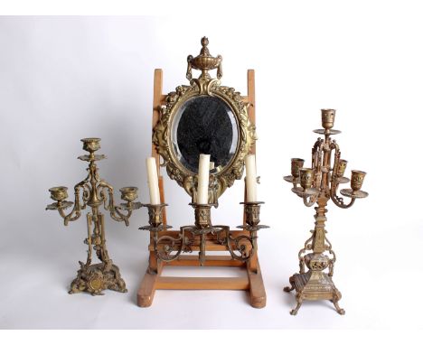A Victorian brass three-branch wall applique, with an oval bevelled plate (cracked), 55cm high; together with two brass cande
