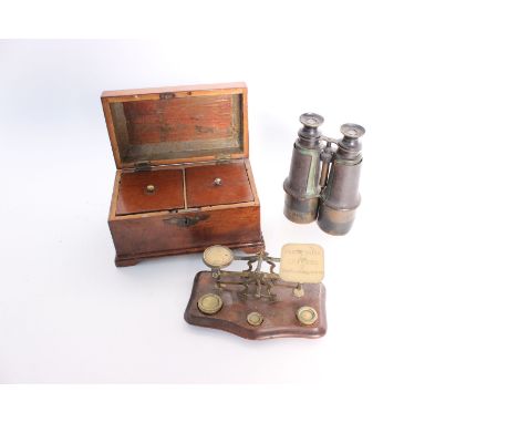 A George III mahogany two-division tea caddy with a domed lid, together with a set of brass postal scales and a pair of binoc