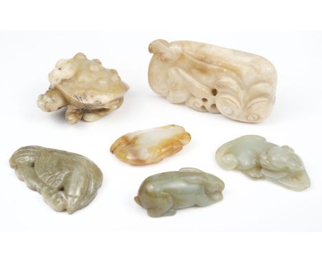 * Jade. A Chinese jade carving of a recumbent feline cub, its head turned back, 60 mm long together with various carved stone