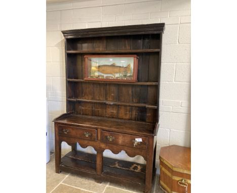 * Welsh Dresser. A cottage-sized oak dresser, 18th century, with three shelf plate rack above a rectangular base with two dra