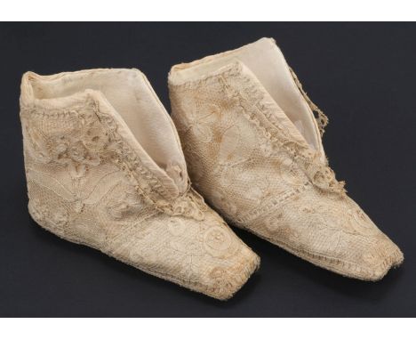 * Lace. A pair of Honiton lace baby shoes, early 19th century, two boottees with square toes, composed of cream bobbin lace a