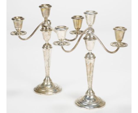 * American Silver. A pair of Newport Sterling silver three-branch candelabra, of plain form and weighted, 31 cm high QTY: (2)
