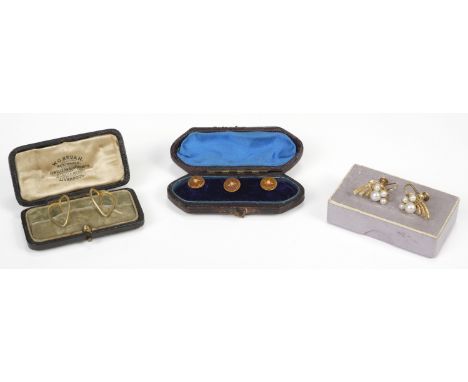 * Earrings. A pair of 14K gold screw-back earrings, set with 4 pearls in a stylised setting, gross weight 5.1g, together with