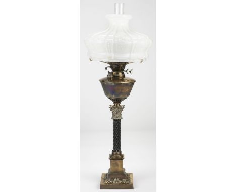 * Oil Lamp. A Victorian brass and ebonised oil lamp, with large white glass shade, over corinthian column base with registrat