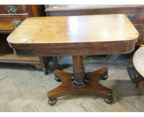 A Victorian Mahogany folding card table on single column and quadrical supports