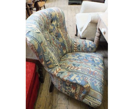 A button back nursing chair with Aztec design upholstery