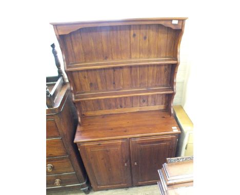 A dark stained Pine shelf backed dresser