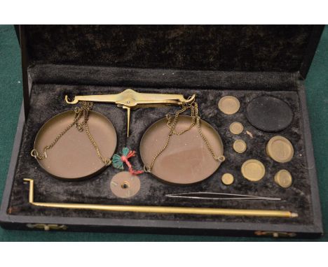 A cased set of scales and weights.