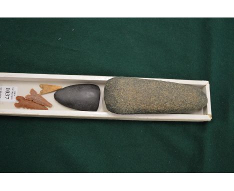 A hand axe, three arrow tips and another item.