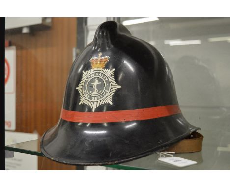 An Admiralty Fire Service helmet.