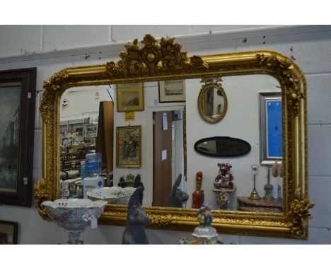 A good large decorative gilt framed over-mantel mirror.