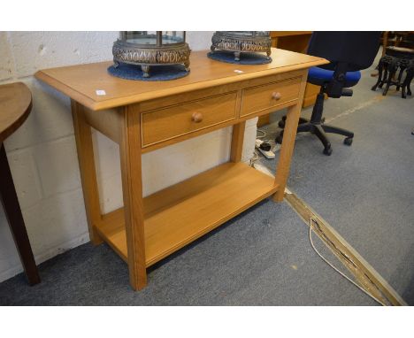A modern light oak two drawer side table.