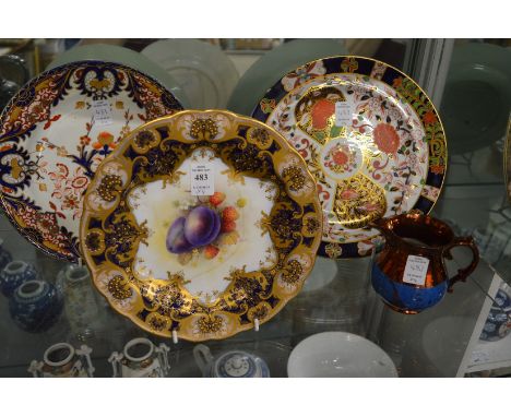 A Royal Worcester fruit decorated plate (faults) and two Crown Derby Imari decorated plates together with a lustre ware jug.