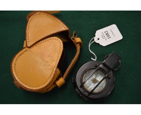 A military compass with leather case.