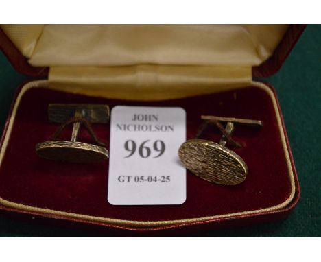 A pair of silver cufflinks.