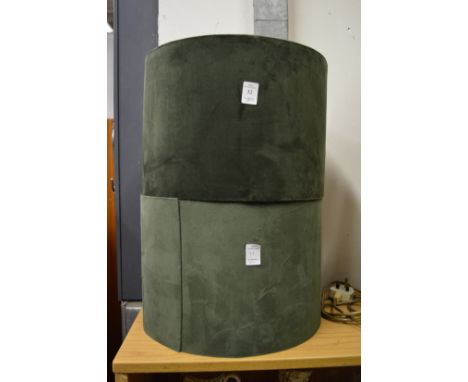 A pair of green velvet lamp shades.