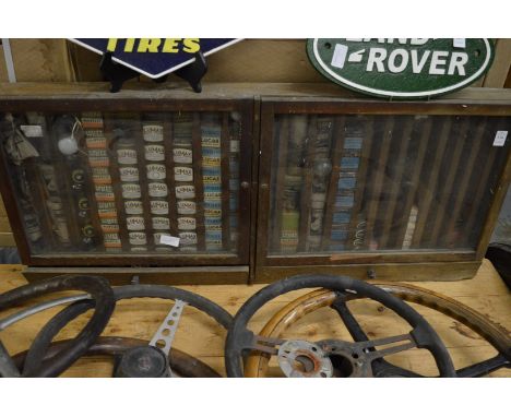 A small wall mounted cabinet containing numerous old car bulbs by Lumaz, Lucas, Philips etc.