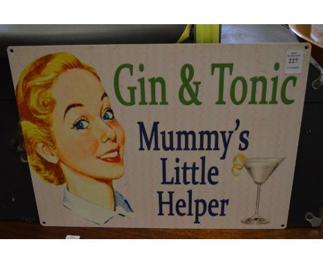A novelty metal gin and tonic sign.