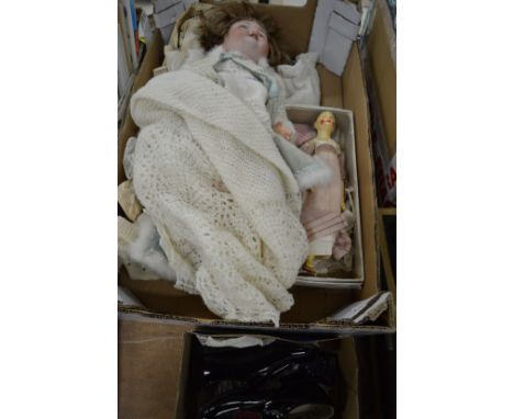 A German porcelain headed doll, a wooden doll and childrens shoes.