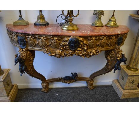 A gilt wood and marble top demi lune console table.
