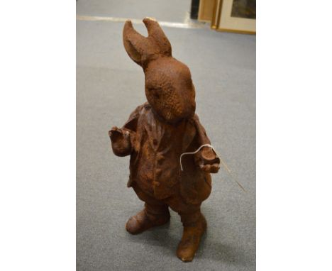 A cast iron model of a rabbit smoking a pipe.