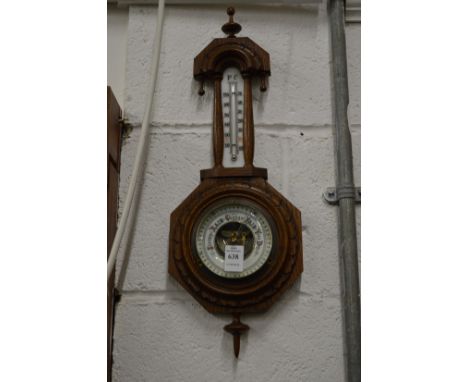 A small carved oak barometer/thermometer.