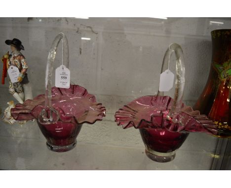 A pair of ruby tinted glass baskets.