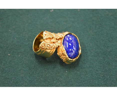 A Yves Saint Laurent gilt metal and blue stone neck tie in original box.
